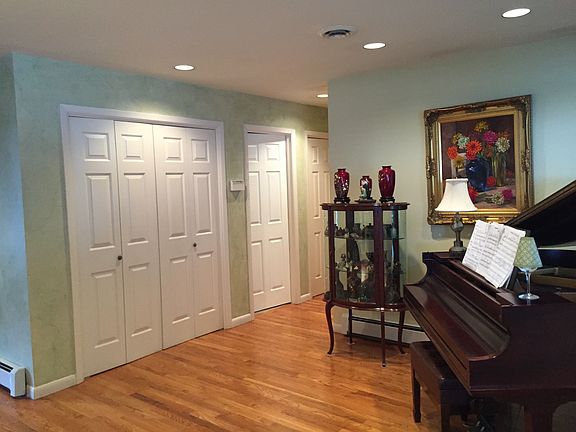 Hallway with coat closets