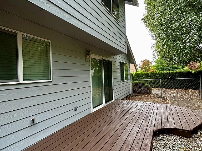 Back of house w/ deck and fully fenced w/ sprinkler system.