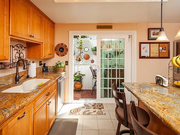 Kitchen opens out to patio and has a nice island with seating.