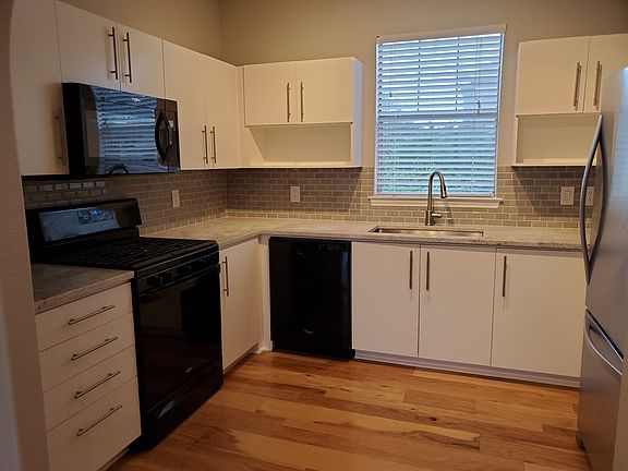 Kitchen with granite counter tops, gas range