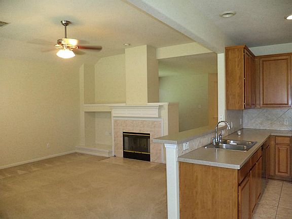 Open Concept kitchen and view to family room with second fireplace.