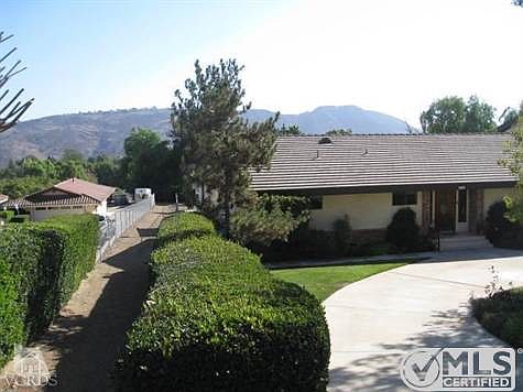 Semi circular driveway; home flanks horse trail