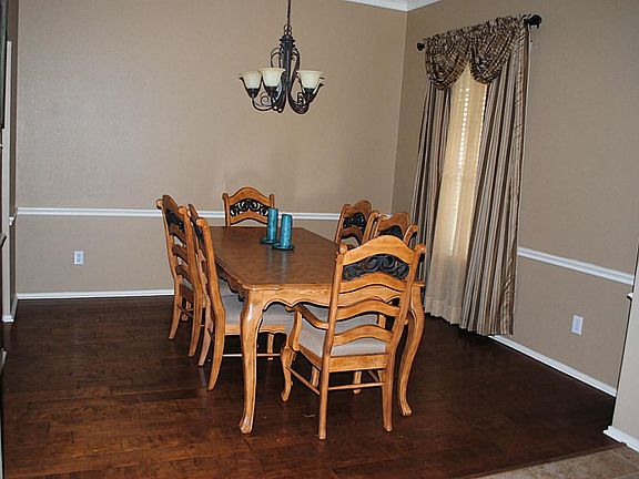 Immediately you will begin to plan your next dinner party as you see this dining room with its rich wood floors.