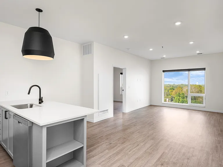 Bright and modern open-concept living space with sleek kitchen island, large windows, and stunning natural views. Bright and modern open-concept living space with sleek kitchen island, large windows, and stunning natural views.