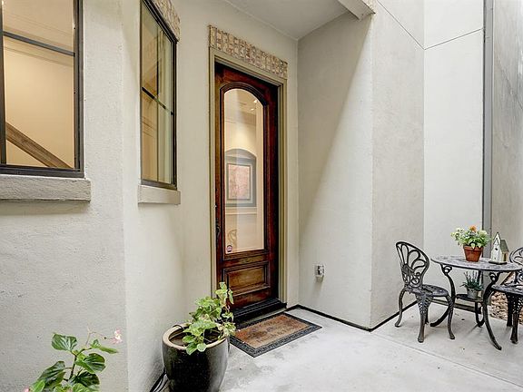 SOLID MAHOGANY FRONT DOOR WITH GLASS INSERT. ENJOY YOUR COFFEE ON PRIVATE PATIO AREA