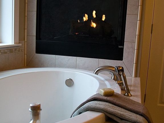 Be careful not to slip into dreamland in this large soaking tub with fireplace