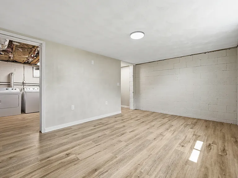 Partially finished basement. To the left is the fully-equipped laundry room.