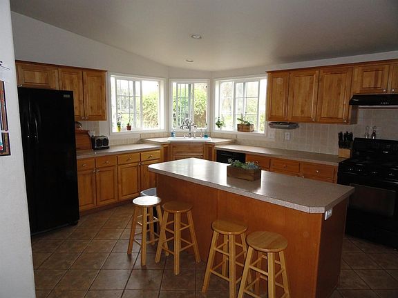 MAPLE CABINETRY, TILE BACK SPLASHES AND A WONDERFUL CORNER SINK!  LOOK AT ALL THIS COUNTER SPACE!!!