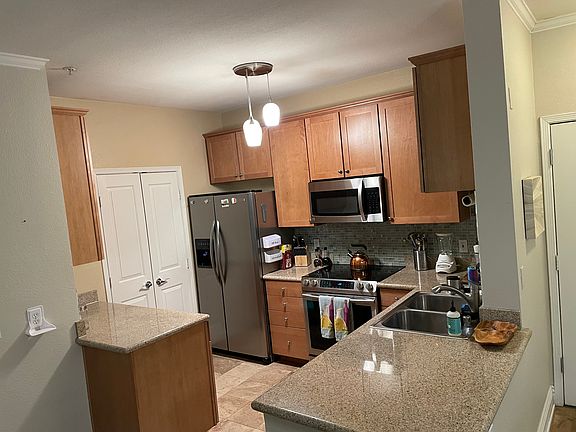 kitchen with upgraded appliances and laundry room behind double doors