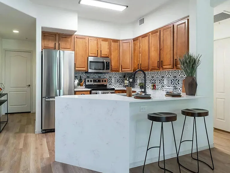 Stylish Kitchen with Stainless Steel Appliances and Bold Tile Backsplash