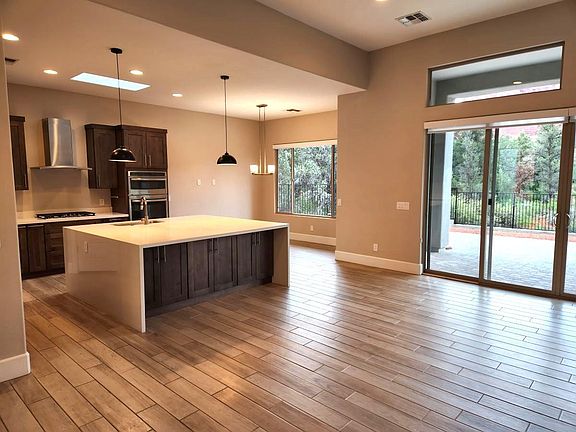 Living room flows seamlessly into kitchen and dining room