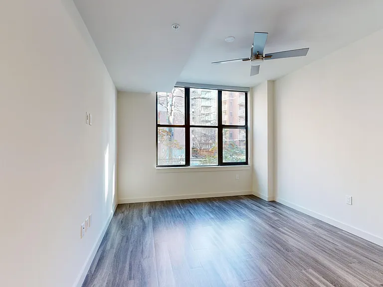 Apartment living room with wood-style flooring.