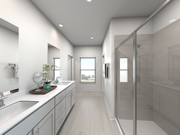 The primary bathroom offers dual vanity sinks and a walk-in closet.