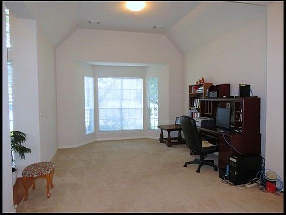 Formal living room has bay window.