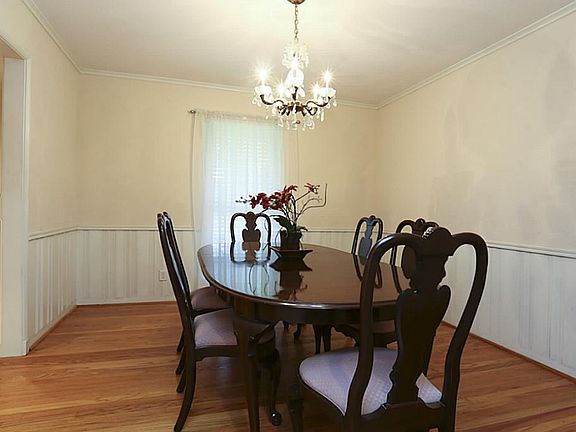 The dining room has hardwood floors and wainscoting.