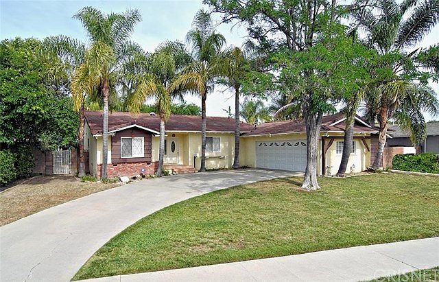Palm trees surround the home.