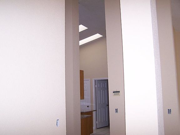 entry to kitchen w/ 2 sky lights