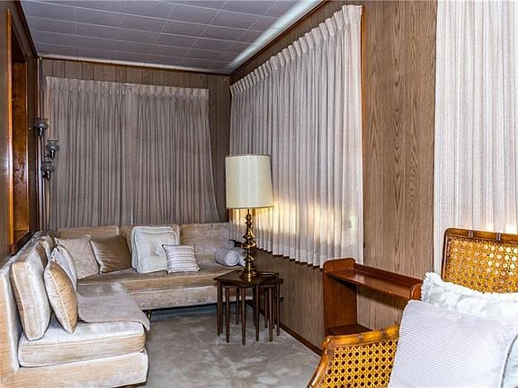 Den on main level with private access to the covered front porch could serve as an office or easily be converted into a bedroom.