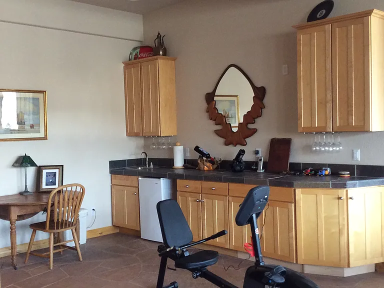 Wet bar with mini fridge and sink.