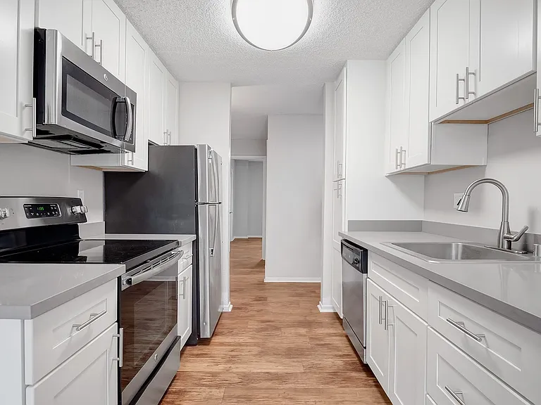 Kitchens feature stainless steel appliances and wood flooring