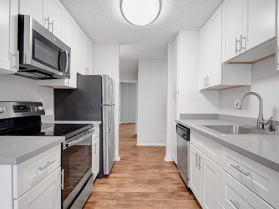 Kitchens feature stainless steel appliances and wood flooring