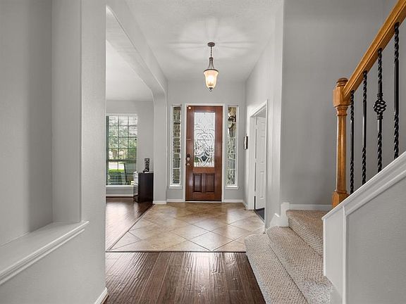 The view from the living room back toward the front door shows the openness of the entryway.