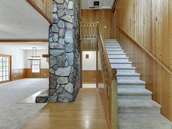 View of vaulted foyer, living / dining room from front entry