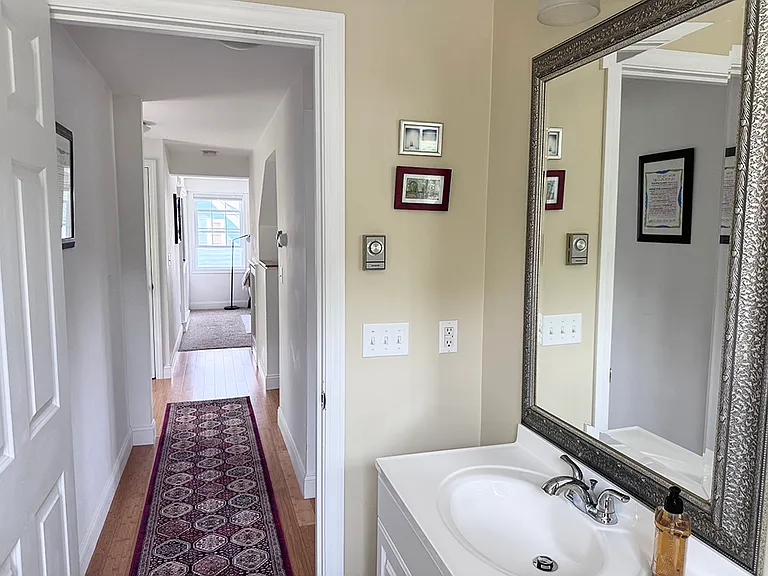 Main floor bathroom looking out towards kitchen and living area.
