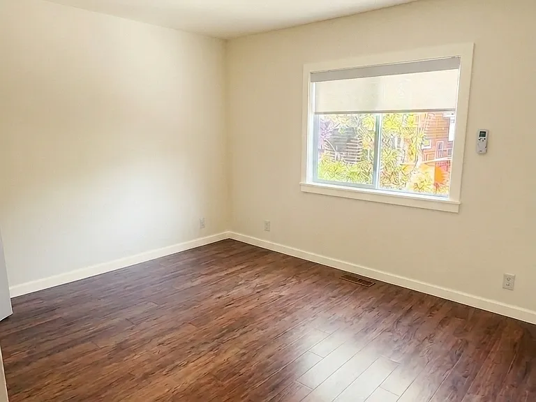 Back bedroom. North-facing over yard with custom, light-filtering, continuous cord top-down blinds.