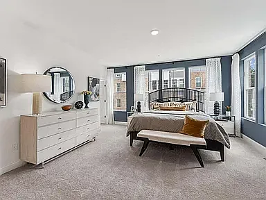 The spacious, thoughtfully designed primary suite offers a private retreat with two walk-in closets and a beautifully appointed en-suite bathroom featuring a dual-sink vanity, a walk-in shower, and a private water closet.