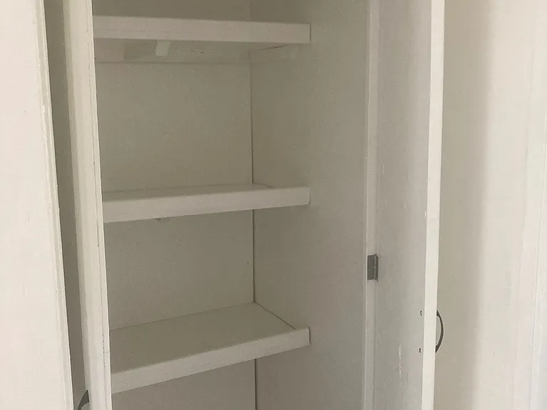 Both doors of the storage pantry open with lots of spacing for storing food, gadgets, iinen or other items