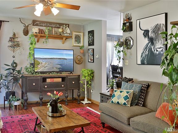 Spacious living room with new vinyl flooring and ceiling fan.
