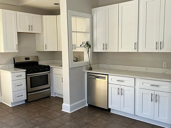 Large, open and bright eat-in kitchen with loads of cabinet storage and stainless steel appliances