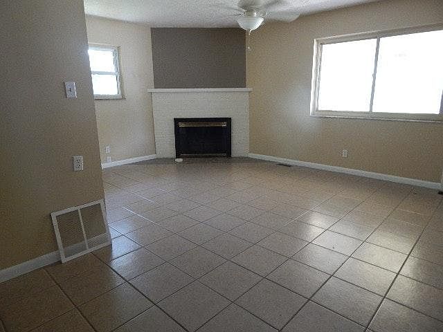 Family room with gas fireplace and ceramic flooring