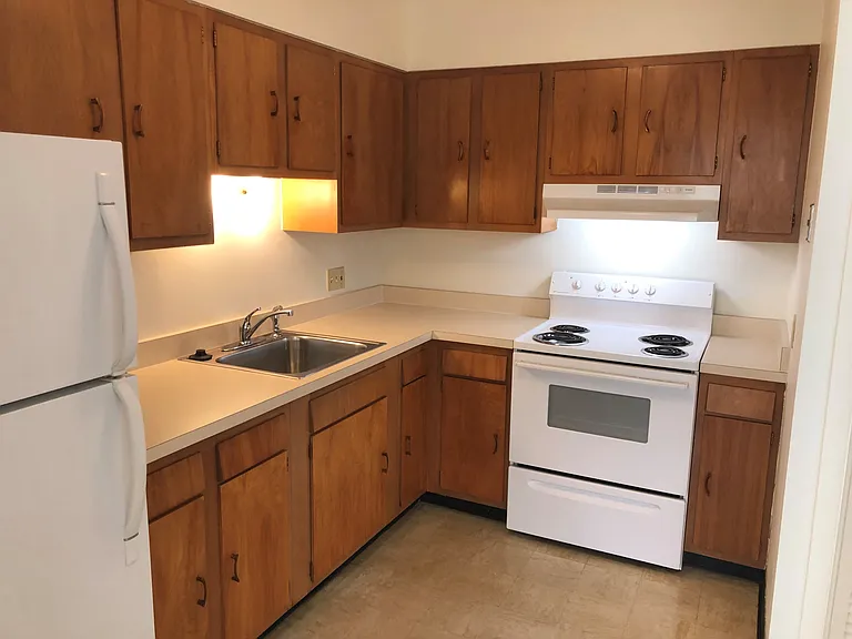 Kitchen has new countertop, sink, and faucet.