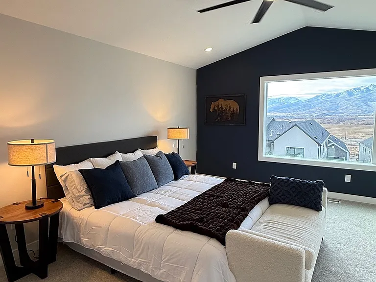 Master bedroom with king bed, ceiling fan, amazing views.