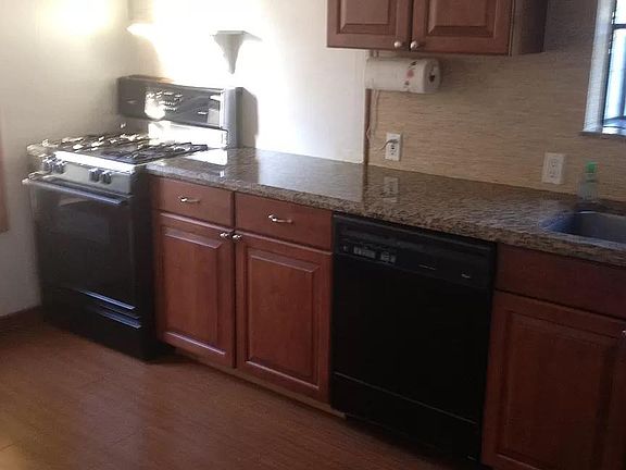 Kitchen with gas stove and granite countertops.