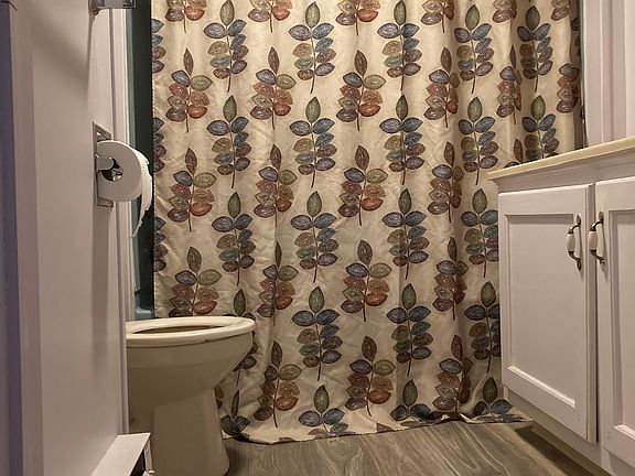 Bathroom with bathtub and shower.