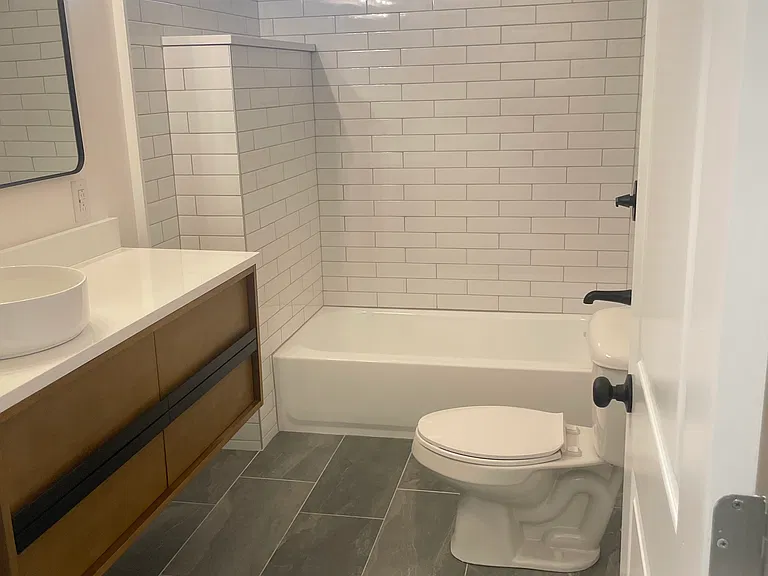 Bathroom with all new flooring, vanity, cabinet, tub, tile, shower, hardware, and toilet. Never been used.
