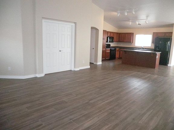 Open concept, front room, dining room, kitchen and double doors into bedroom.