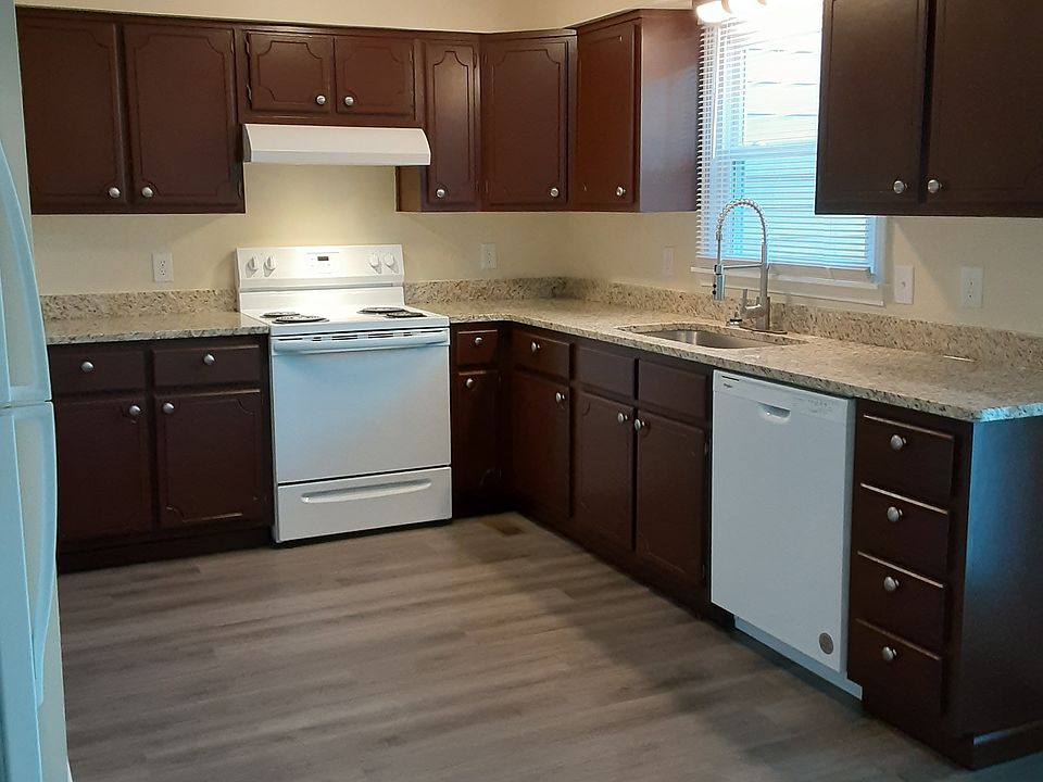 Your standing in dining room, looking at Kitchen with all new paint, flooring, cabinets with granite counter tops with large deep sink and appliances, window and lighting. To left of photo is washer/dryer hook up not seen in photo.