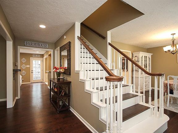 Welcome inside! Custom wood staircase and hardwood flooring really set the stage for this well loved home.