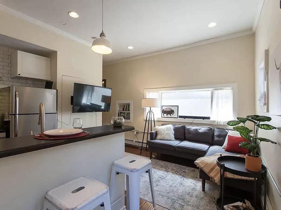 Open, airy kitchen with eat-at bar. Stainless appliances and pendant lighting.