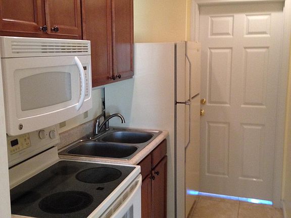 Kitchen; door pictured enters shared laundry space