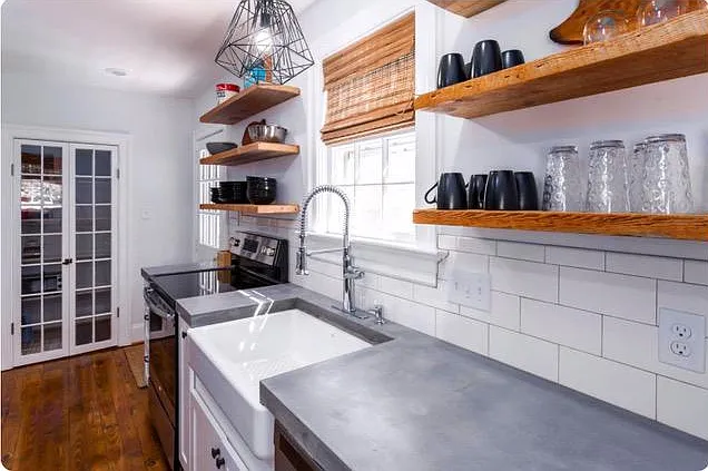 Kitchen with walk-in pantry and door to outdoor patio area.
