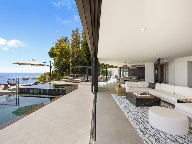 Experience seamless indoor-outdoor living as the living room opens directly onto the expansive patio.