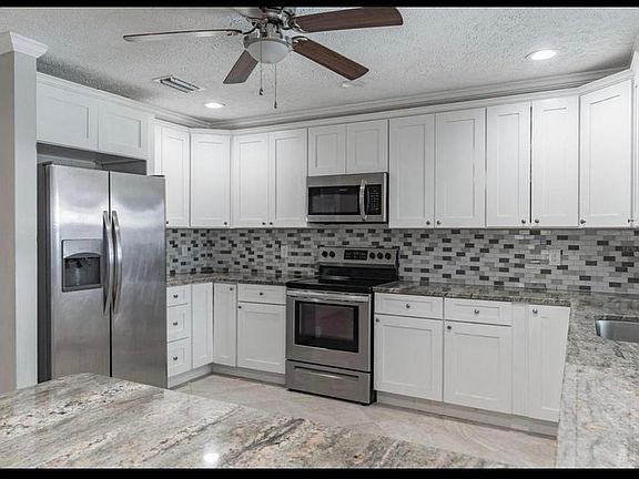 Spacious Kitchen, counter for seating, stainless steel appliances and beautiful granite countertops.