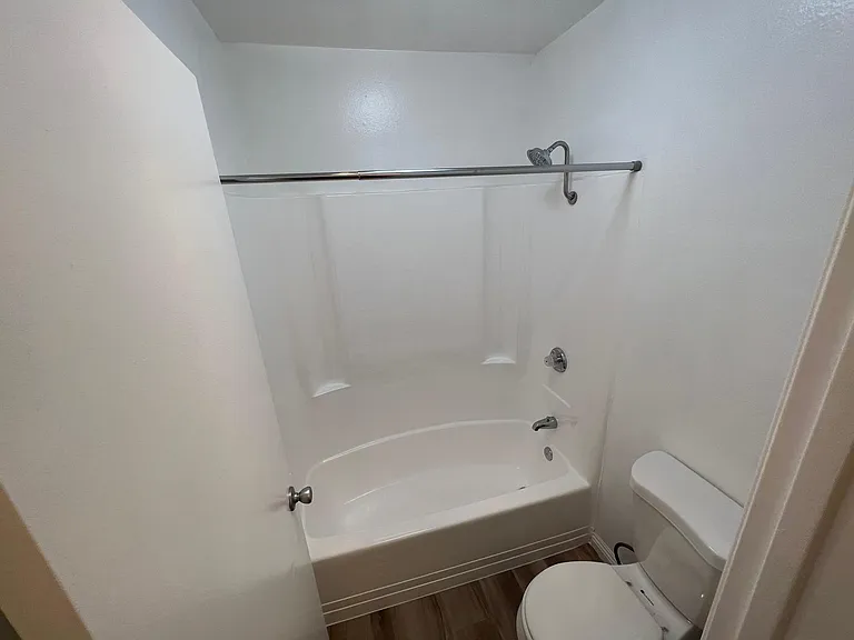 Private toilet and shower in 1x1 bathroom. Vanity sink area is separate.