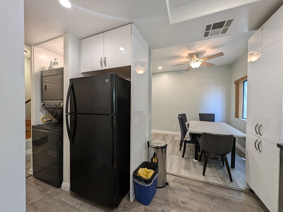 Washer & Dryer on the left of the photo. Refrigerator. Trash cans. Then dining table for up to 6. Then Linen Cabinet.