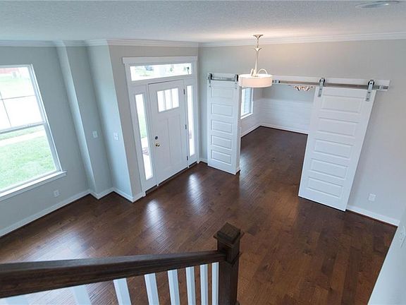 Wide plank distressed look wood floors through out first floor of this home. Barn doors and Shiplap in the dining room.